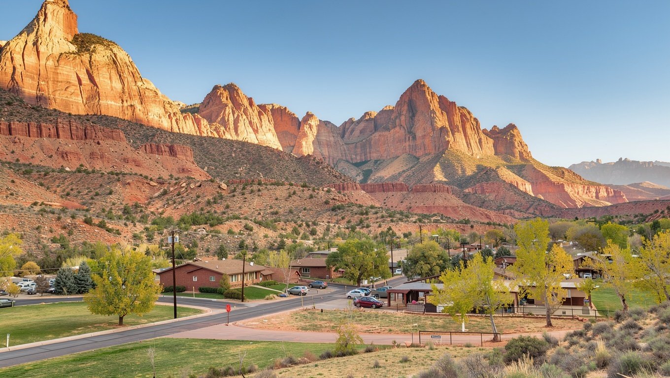 Springdale, Utah at the gateway to Zion, with low lodges below towering red sandstone cliffs